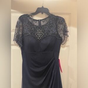 Floor length dress. Perfect for weddings or upscale events. Dark blue in color.
